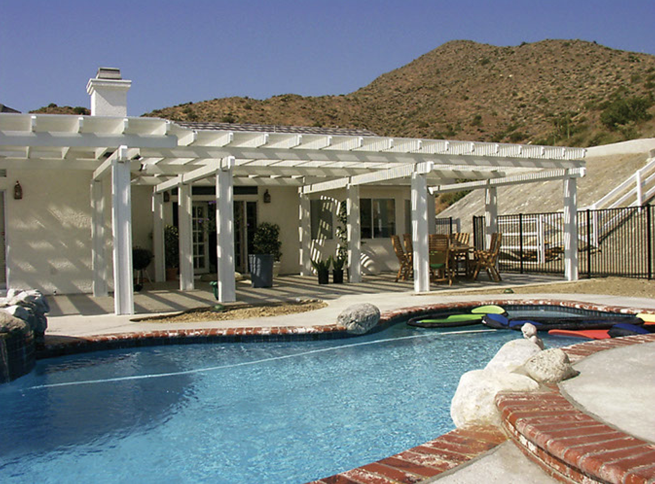 Shaded patio next to inground pool